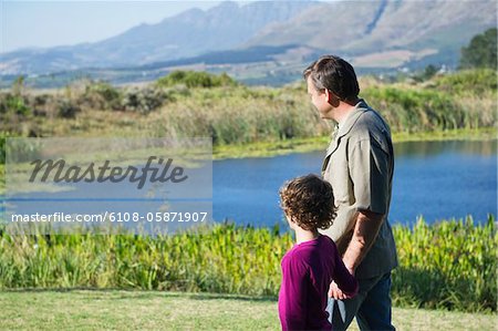 Father and son looking at the pond