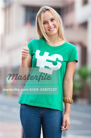 Portrait of beautiful woman showing thumbs up sign