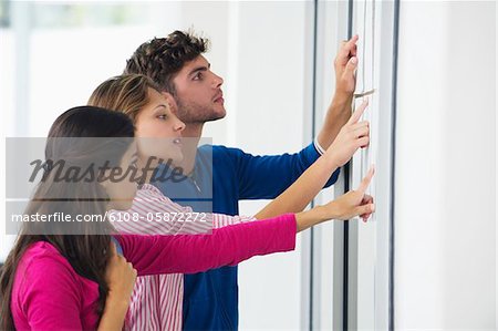 University students checking bulletin board for test result