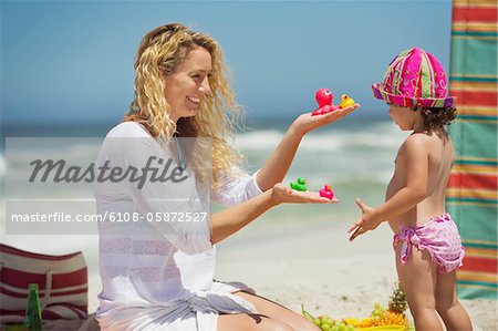 Woman giving toys to her daughter