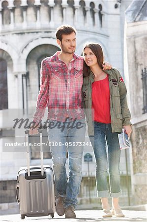 Couple walking on a road with a suitcase, Paris, Ile-de-France, France