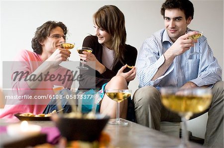 Couple and man drinking champagne