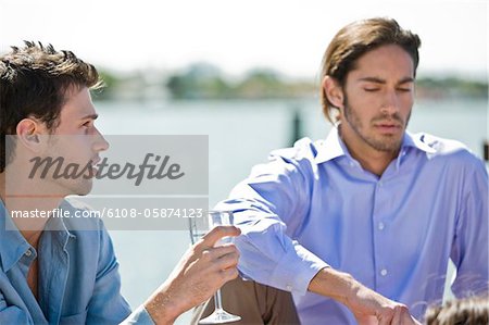 Man enjoying drink with his friend