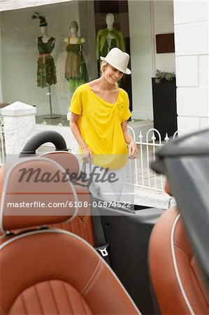 Woman walking towards a car after shopping