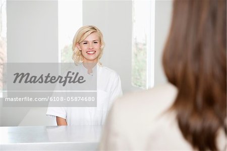 Female nurse looking at a woman and smiling