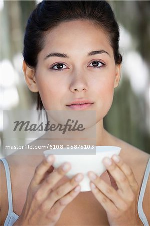 Portrait of a beautiful young woman holding a bowl