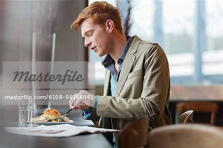Man sitting in a restaurant taking lunch