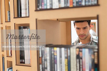 Man choosing books from a bookshelf