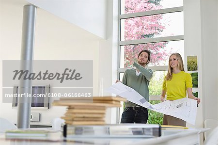 Interior designer discussing plan with a woman