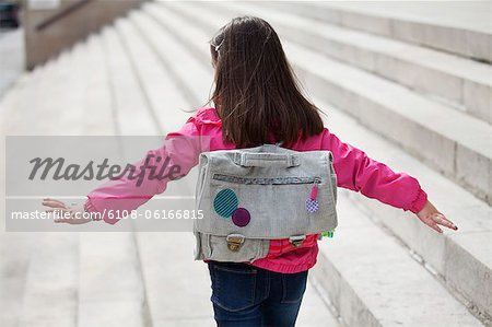 Rear view of a girl walking on the steps