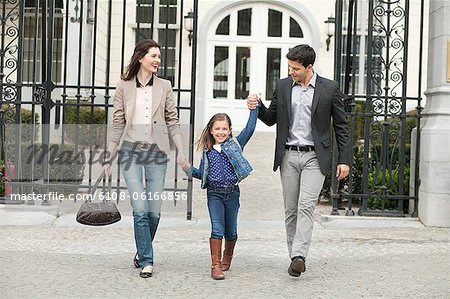 Portrait of a girl walking with her parents