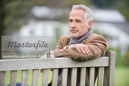 Man sitting on a bench and thinking in a park