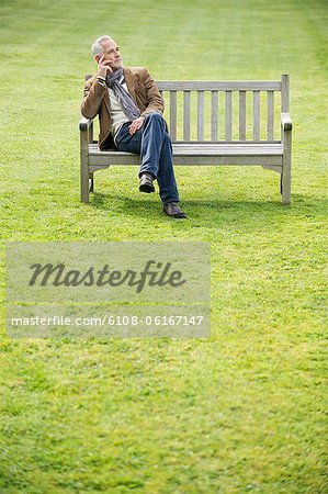 Man sitting on a bench and thinking in a park