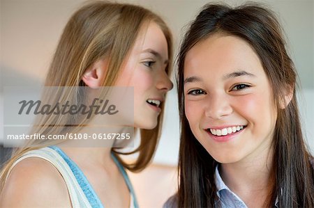 Girl whispering to her friend