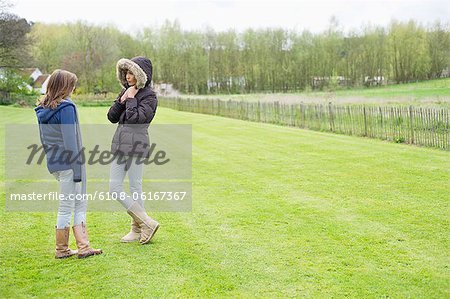 Woman with her daughter standing in a field