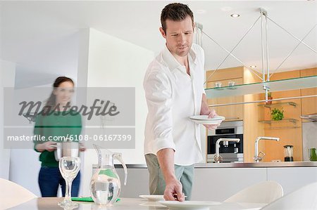 Couple preparing to serve dinner