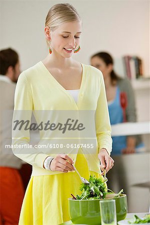 Woman mixing salad in a bowl