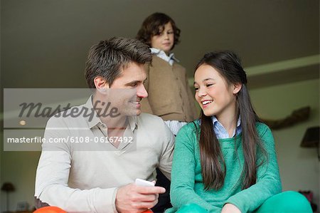 Man sitting with his daughter at home
