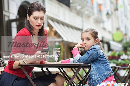 Woman with her daughter sitting in a cafe