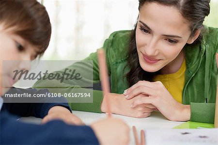 Woman teaching her son at home