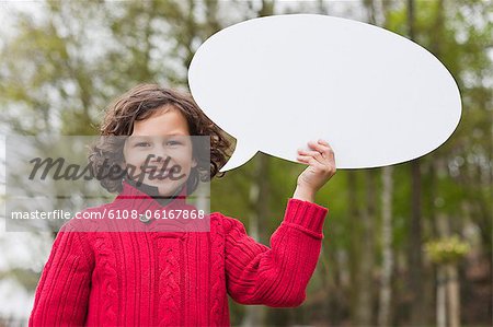 Portrait of a boy holding a speech bubble