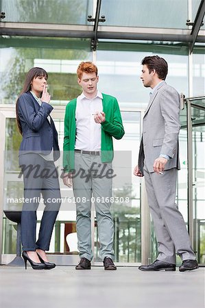 Business executives smoking in front of an office building