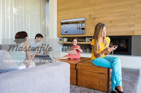 Family using electronics gadgets Family using electronics gadgets