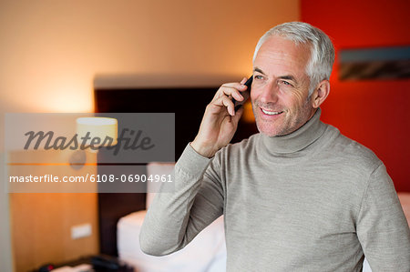 Man talking on a cell phone in a hotel room