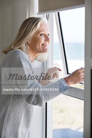 Woman looking through a window