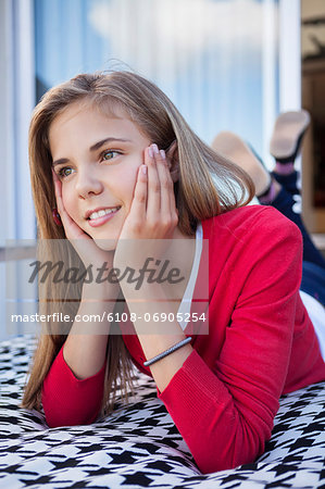 Girl lying on the bed and day dreaming