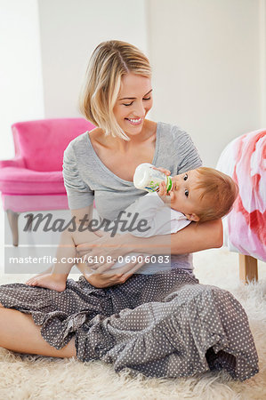 Woman feeding milk her baby with a bottle