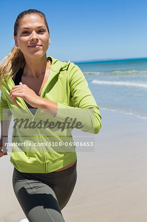 Portrait of a woman running on the beach