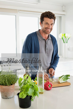 Man chopping vegetables in a kitchen