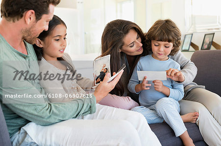 Parents showing photographs to their children
