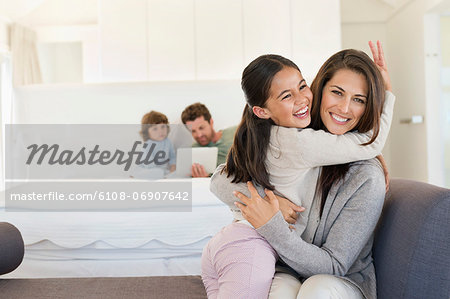 Portrait of a woman hugging her daughter