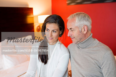 Couple sitting together in a hotel room