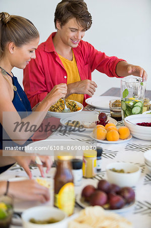 Friends sitting at a dining table having lunch