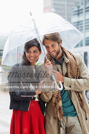 Smiling couple under umbrella