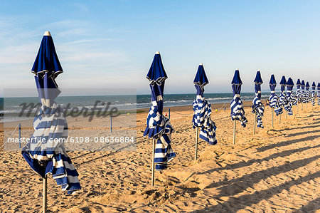 France, Normandy, beach umbrellas at the end of a summer day on the beach of Cabourg