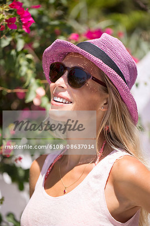 Young smiling woman with a sunhat