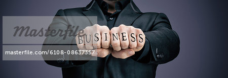 Businessman tattooed fists