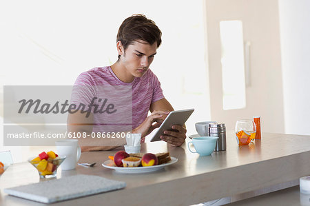 Close-up of a young man using a digital tablet