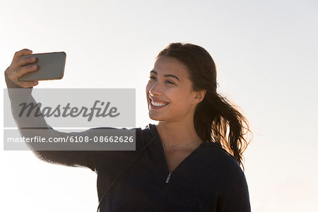 Happy woman taking selfie with a smart phone