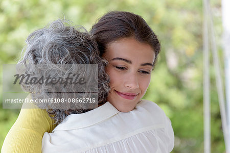 Loving mother hugging her adult daughter