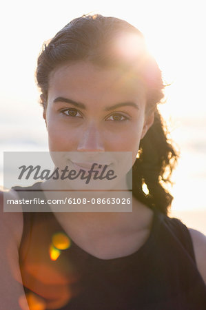 Portrait of a happy young woman standing on the beach