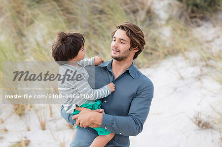 Close-up of a man carrying his son