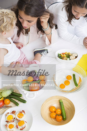 Happy young family preparing vegetables at home