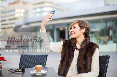 Woman doing a selfie outdoors in a Cafe