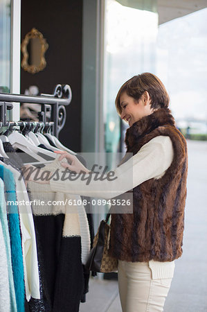 Woman searching fot clothes in a store outside