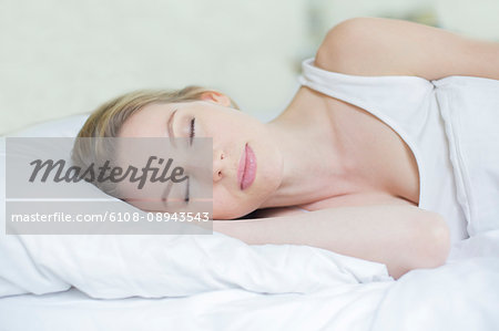 Portrait of a beautiful woman sleeping in bed